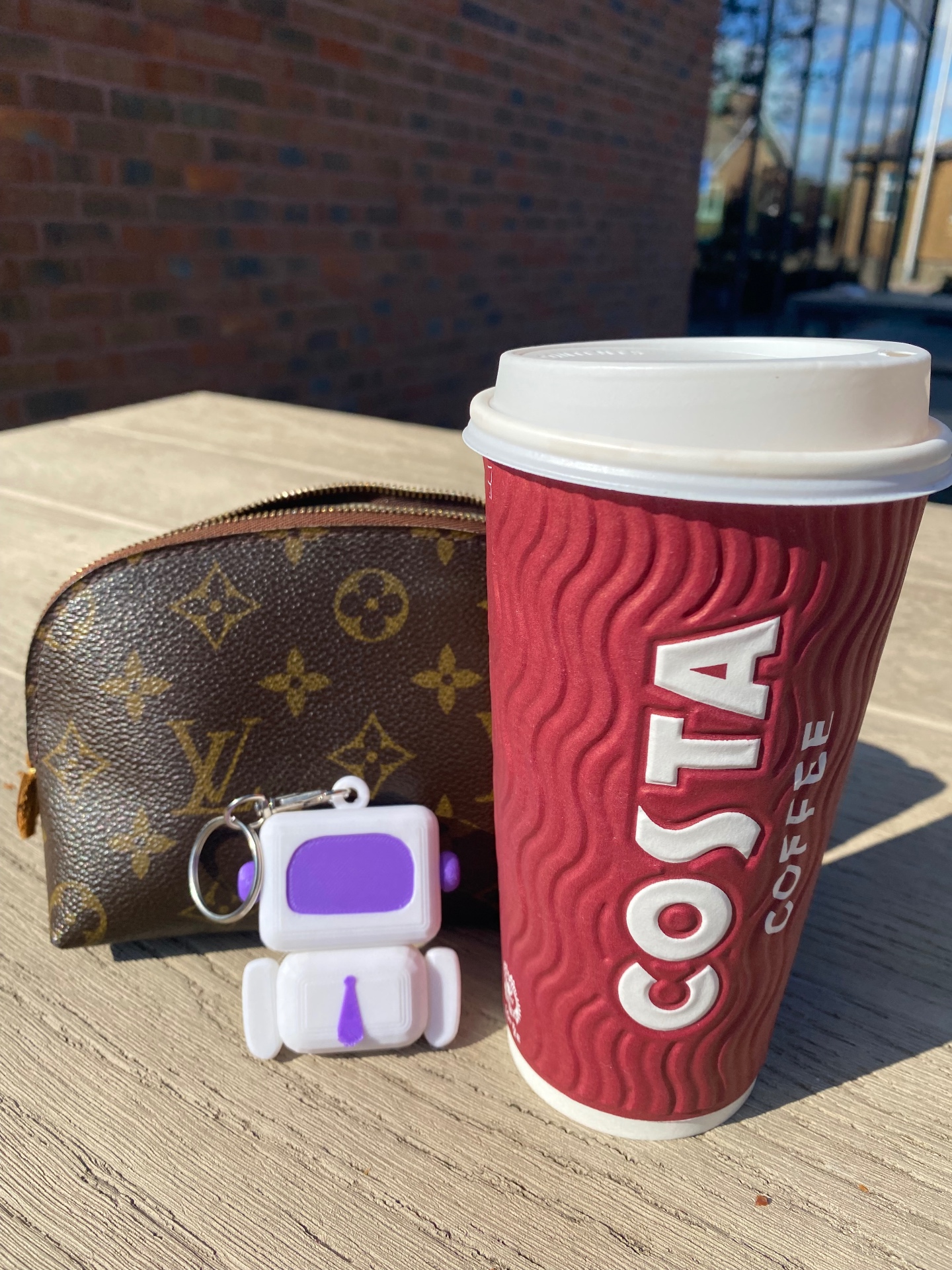 Arty next to a Costa coffee cup on a sunny morning
