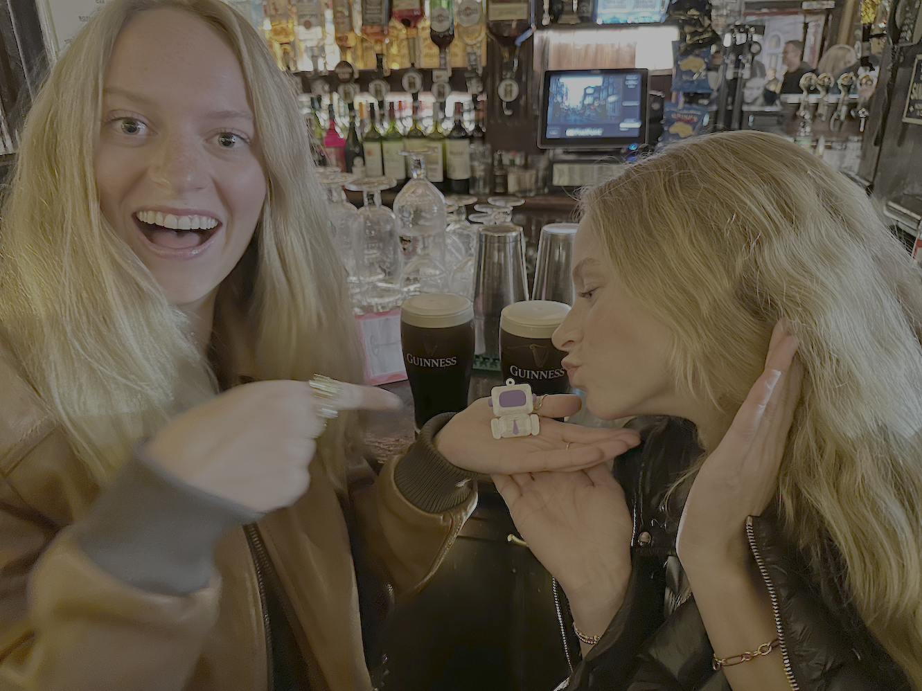 Two friends posing with ARTY at a Guinness bar