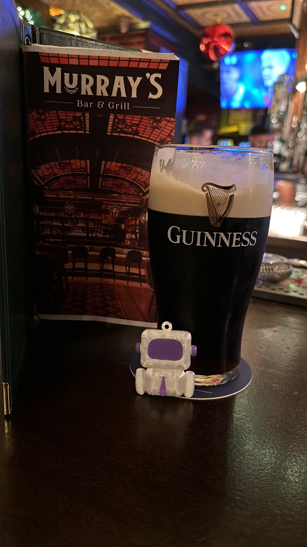 Arty posing in front of a pint of Guinness at Murray's Bar and Grill